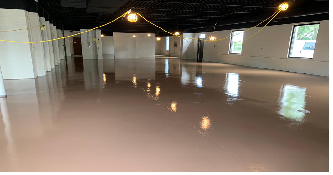 Glossy brown epoxy floor in an open event space